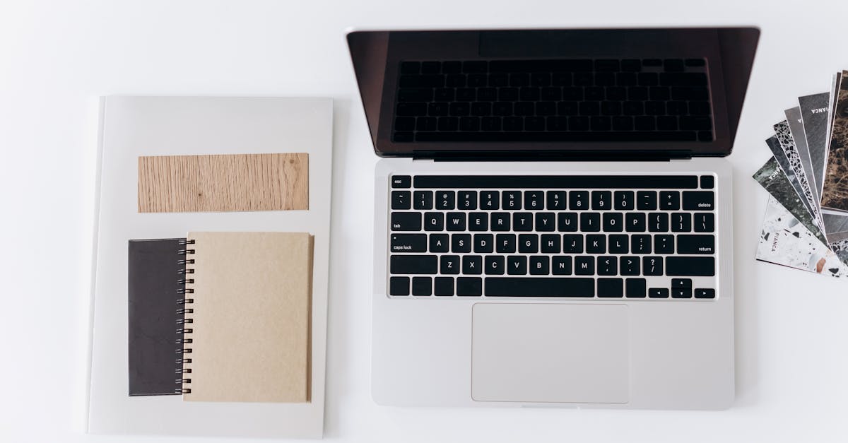 Website maintenance handoff documentation on a laptop and notebook.