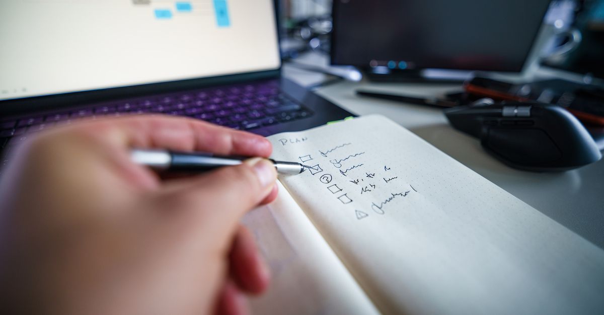 A monthly Drupal portfolio maintenance session: a laptop, a checklist, and a cup of coffee.